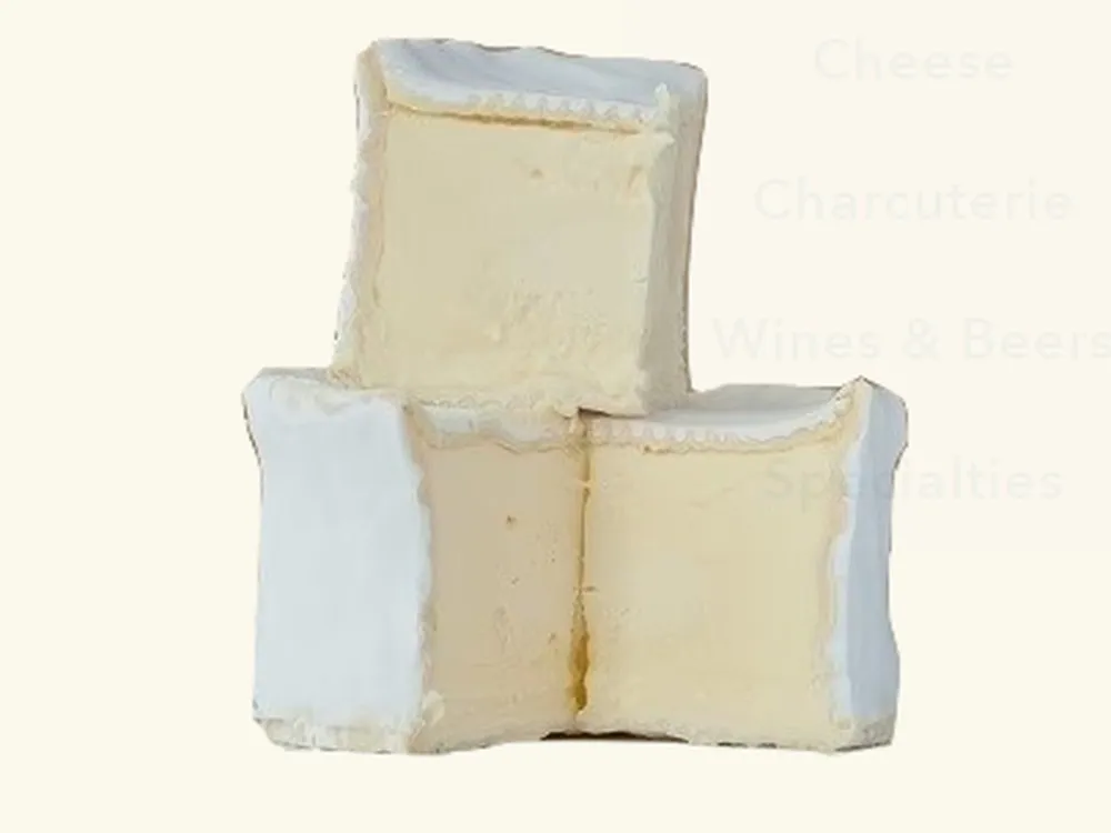 Stacked, partially cut Brillat-Savarin cheeses revealing their soft interior and delicate, white bloomy rind, set against a white background