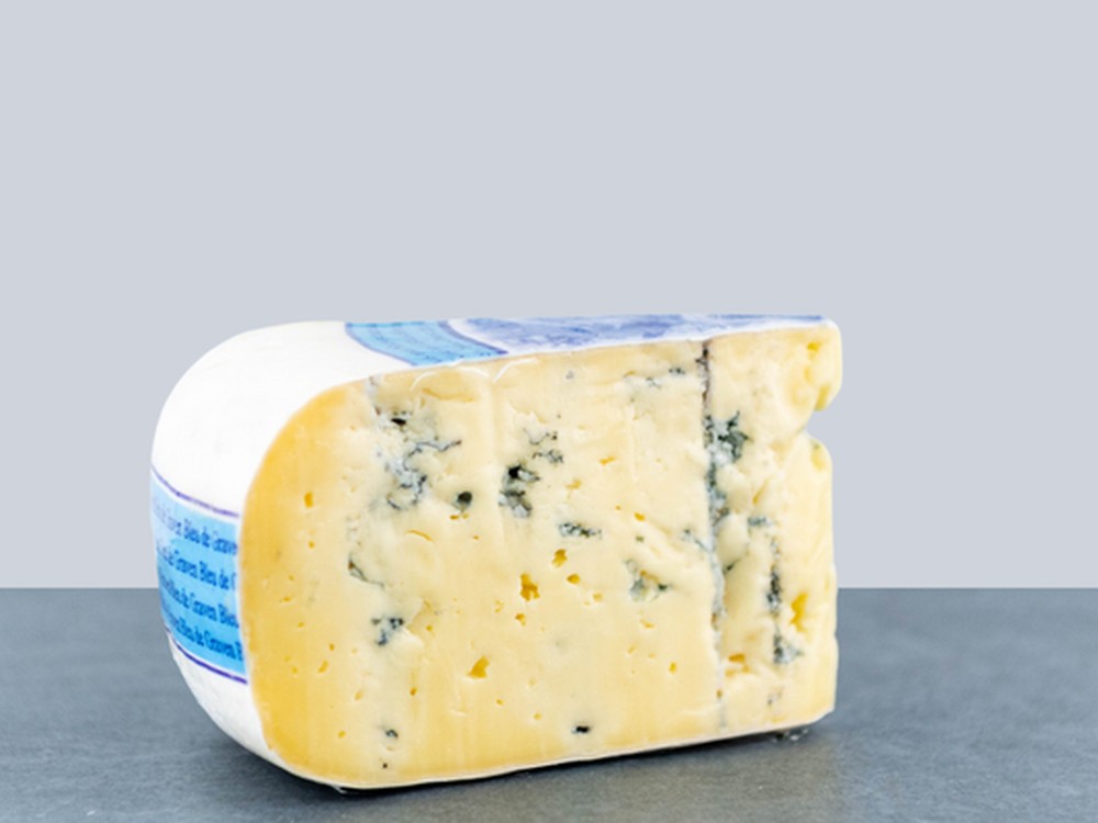 A slice of Dutch Blue cheese on a flat surface