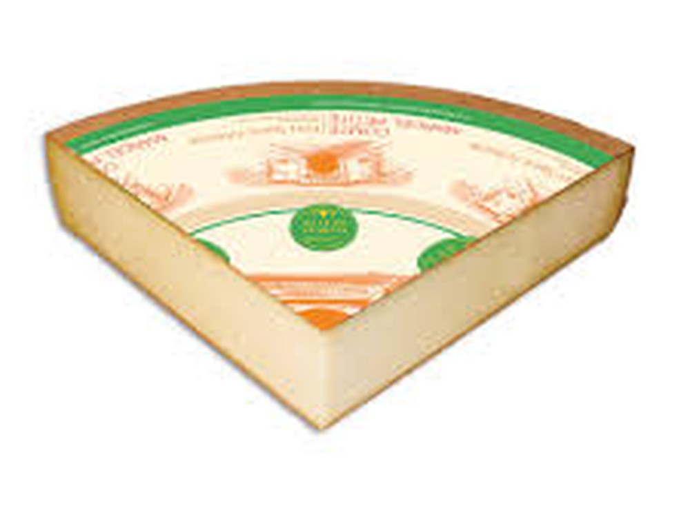 A triangular slice of Comté St. Antoine (Comté AOC Fort St. Antoine), with a label on top, is set against a white background