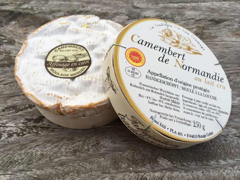 Camembert de Normandie cheese comes beautifully packaged in a round carton, featuring its name and other details on the label