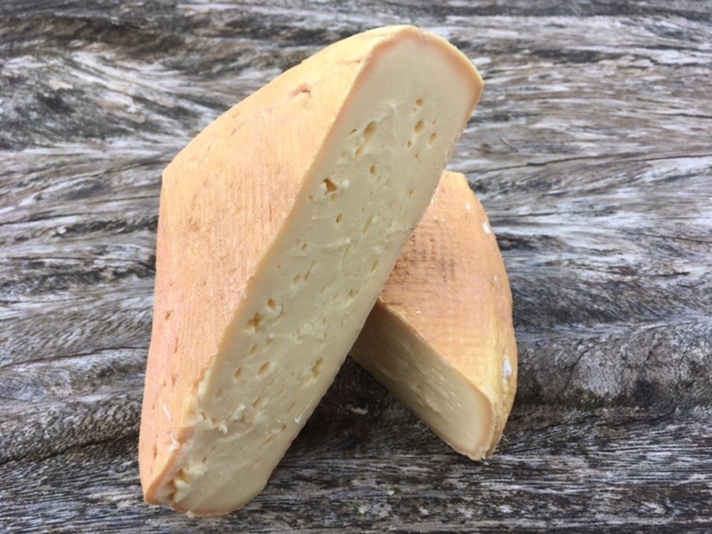 Slices of Highmoor cheese arranged on a wooden surface