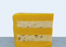 A wedge of Huntsman Cheese, displaying layers of Double Gloucester and Blue Stilton