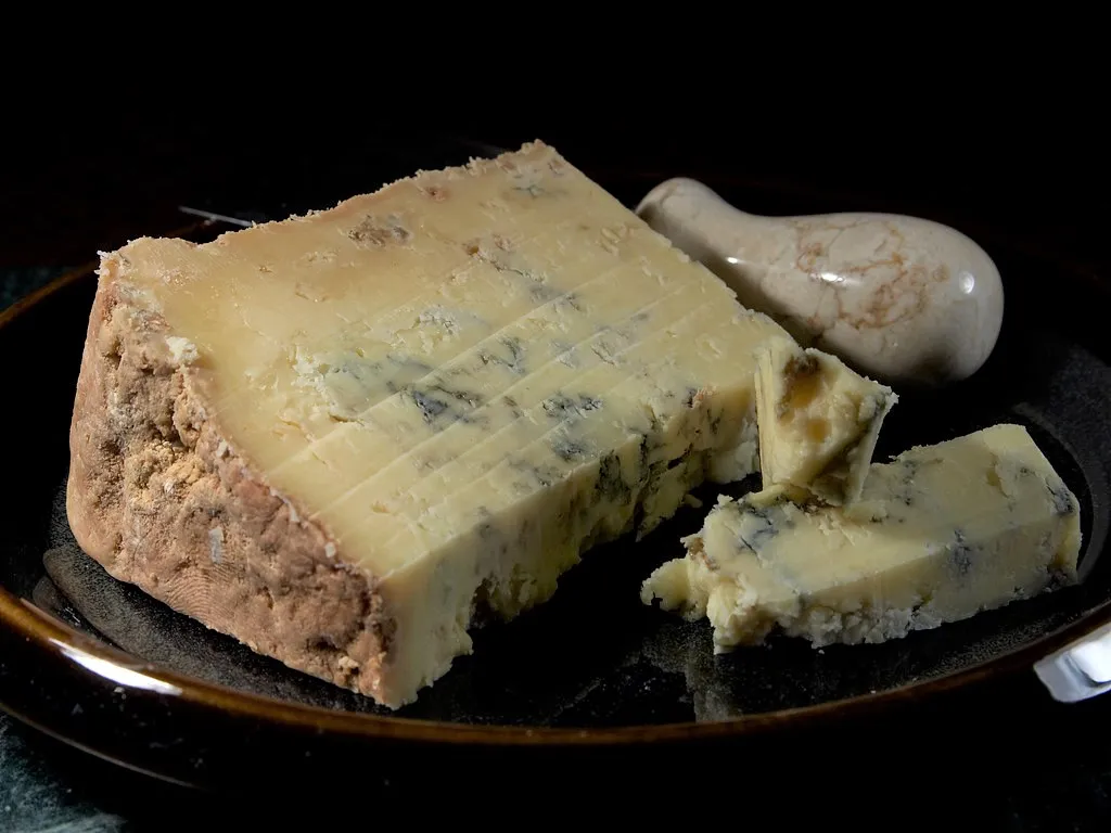 Slices of Dorset Blue Vinny cheese on a black plate