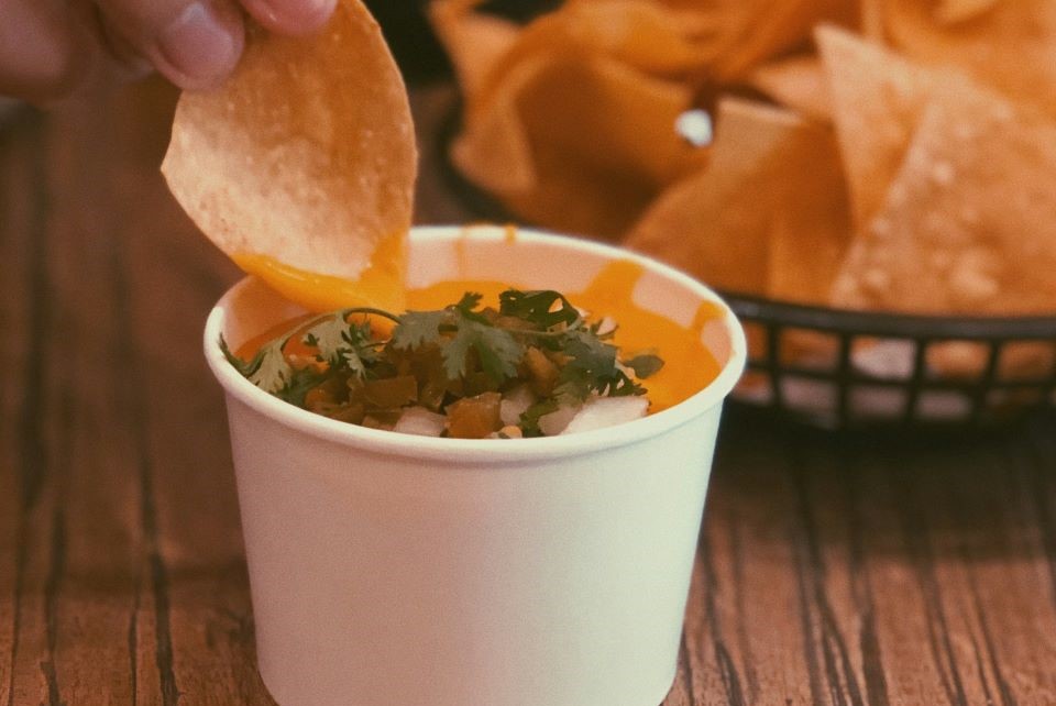 Man enjoying cheesy nachos